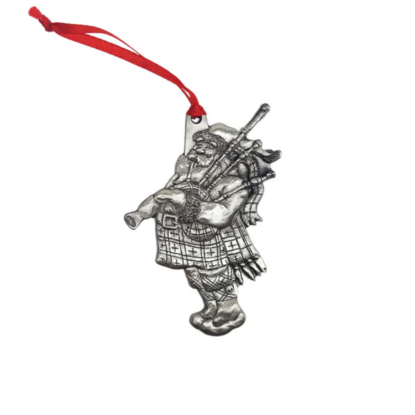 A silver Dancer Ornament with a Scottish man holding a bagpipe.
