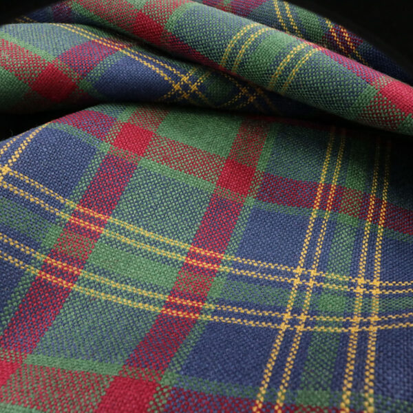 A close up of a plaid fabric, highlighting the difference in its intricate Tartan pattern.