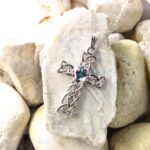 A Mystic Celtic Cross Necklace with a crystal in the middle.