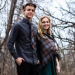 A man and woman sporting the OUTLANDER Golf Cap Authentic Premium Wool Tartan posing for a photo in the woods.