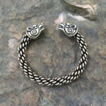 A Celtic Bear Torc Bracelet with a viking head on it.