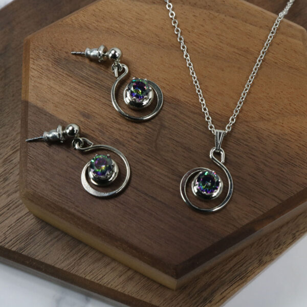 A silver necklace and earrings set with the Triquetra Sterling Silver Earrings.