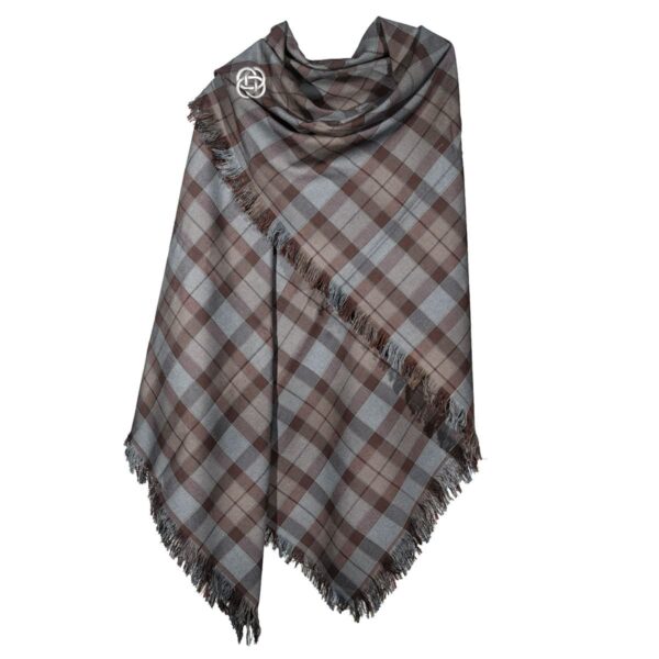 A plaid shawl with fringes and an Eternity Knot Pewter Brooch motif on a white background.