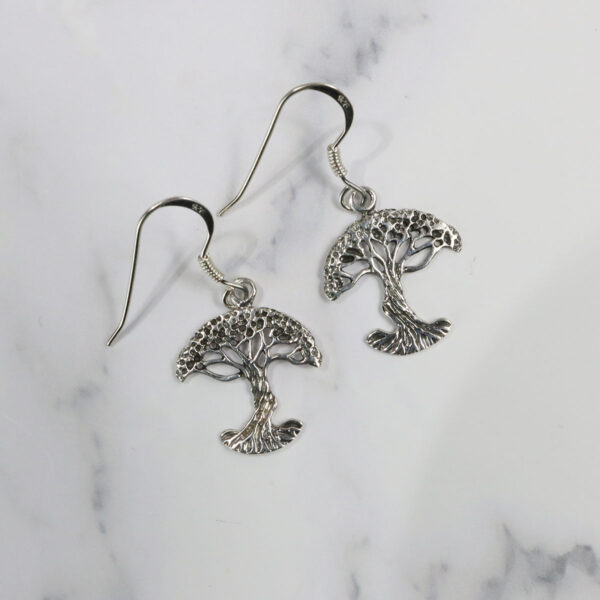 Triquetra Sterling Silver Earrings, named the "Triquetra Sterling Silver Earrings," feature a tree of life emblem.