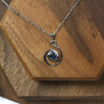 An Amethyst Celtic Knot Necklace with an amethyst stone.