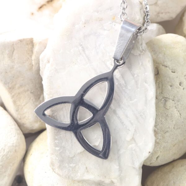 A stainless steel triquetra necklace, also known as a trinity symbol, delicately designed on it.