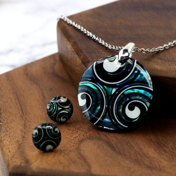 A Triskelion Spiral Paua Shell necklace and earring set.