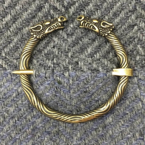 A bracelet with two dragon heads on it.