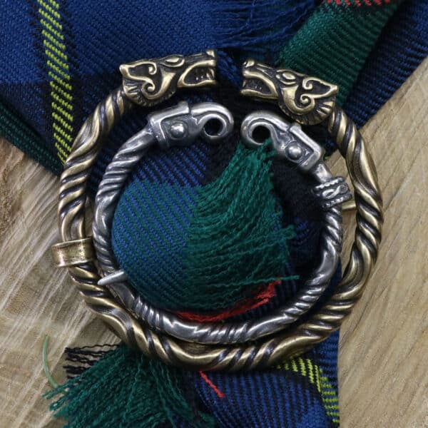 A blue and green tartan with a metal ring on it.