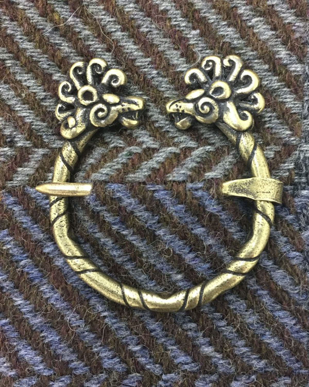 A pair of brass rings with flowers on them.