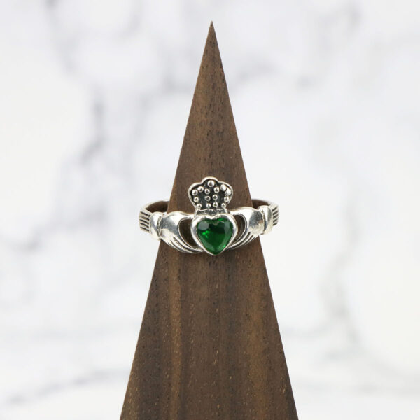 A large Celtic Knot Spinner Ring with an emerald stone.