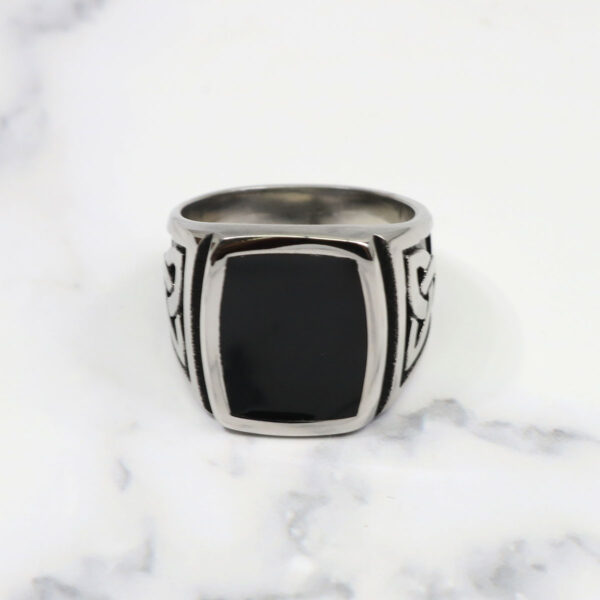 A silver ring with a Black Onyx Stainless Steel Triquetra Ring stone.
