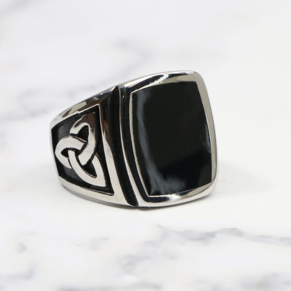 A Black Onyx Stainless Steel Triquetra Ring with a black onyx stone.