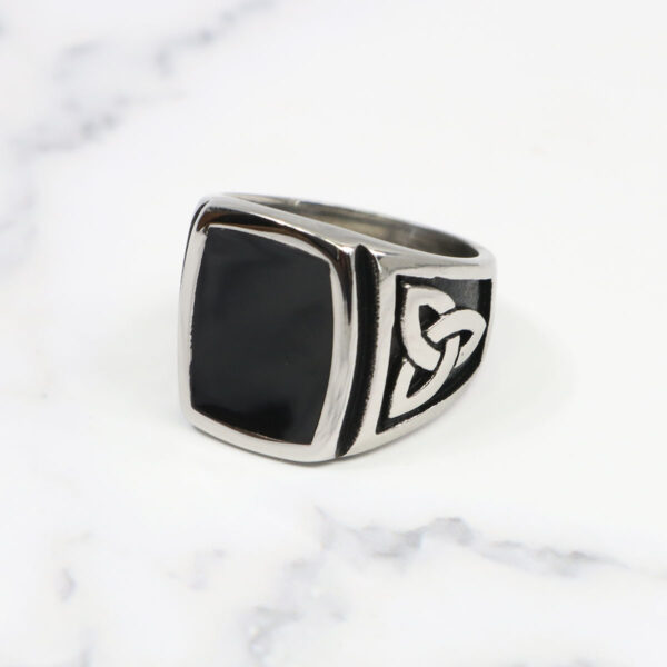 A Black Onyx Stainless Steel Triquetra Ring with a silver band.