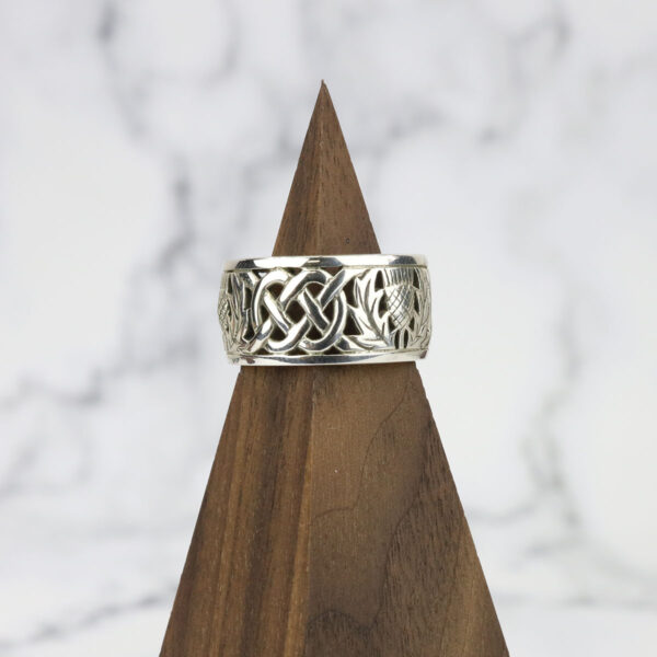 A silver ring with a Two Tone Eternity Knot Band and celtic design.