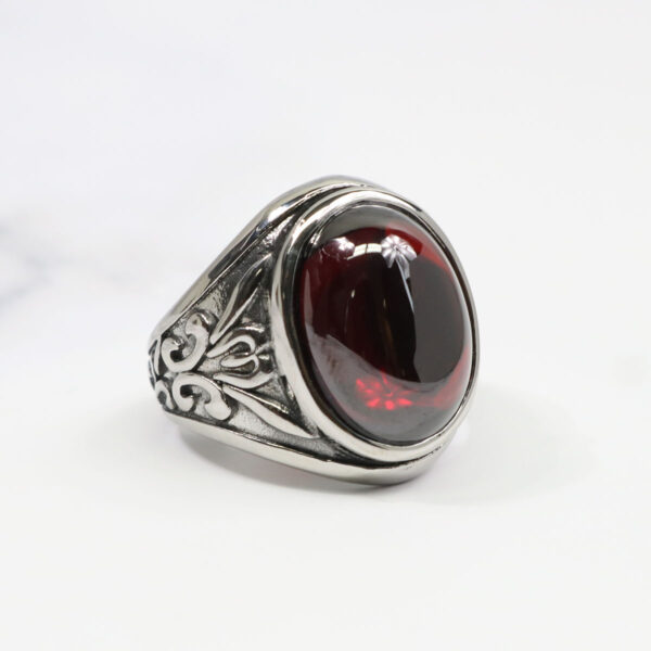 A Dragon's Eye Ring with a silver band and a vivid red stone.