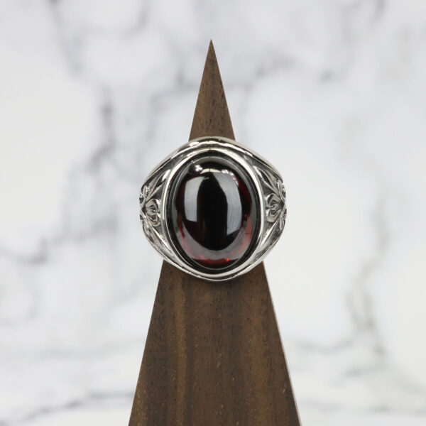 A stunning Dragon's Eye Ring featuring a mesmerizing garnet stone, crafted with sterling silver.