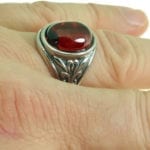 This Dragon's Eye Ring features a chunky red oval gem set on a thick decorative filigree band