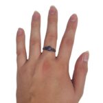 A woman's hand with a Purple Mohave Turquoise Triquetra Ring.