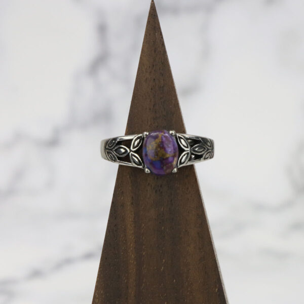 A silver ring with a Purple Mohave Turquoise Triquetra Ring stone on top.