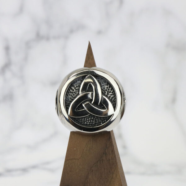 A stainless steel triple triquetra ring.