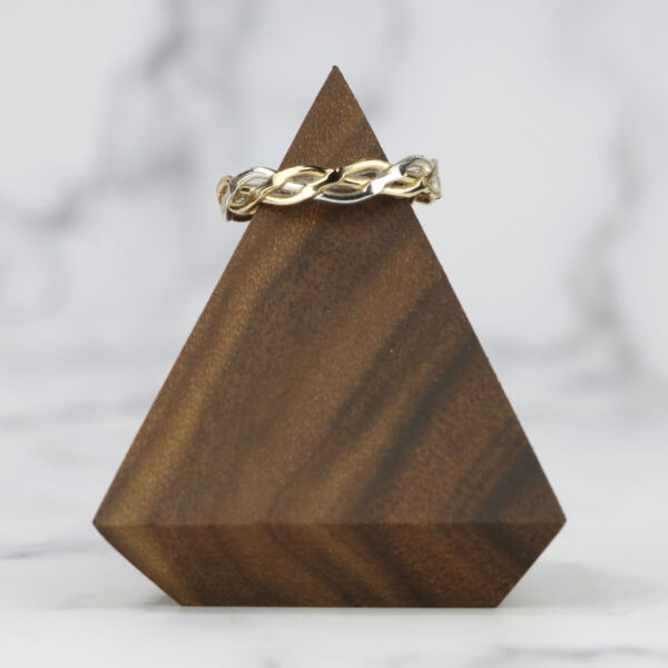 A wooden triangle with a Two Tone Eternity Knot Band.