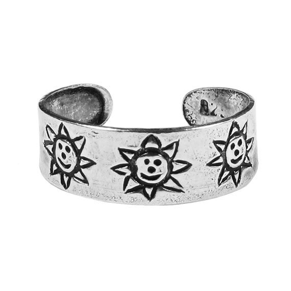 A silver cuff with three Smiley Sun Sterling Silver Toe Rings on it.