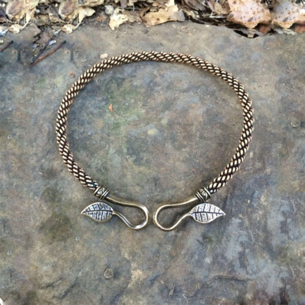 A bracelet adorned with braided leaves, inspired by the elegance of Ash Leaf Torc Medium Braid torcs.