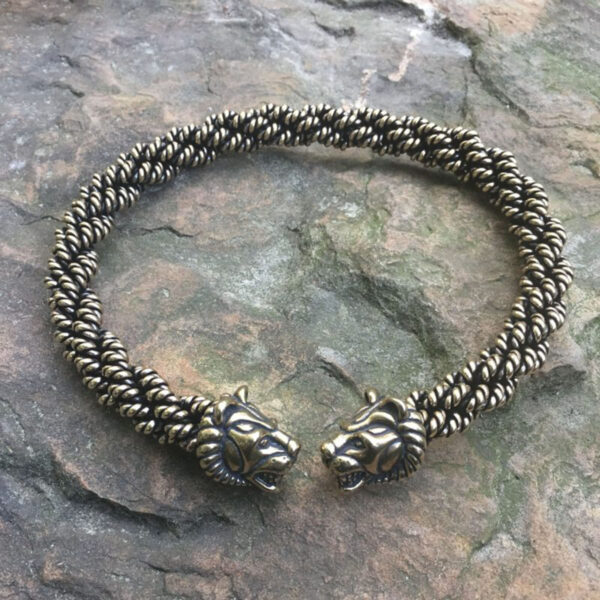 A Celtic Lion Torc - Extra Heavy Braid bracelet with two lion heads on it, featuring a torc design.