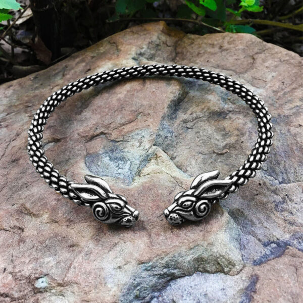 A Rabbit Torc Medium Braid with two dragon heads on top of a spiral.