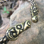 A Celtic Ram Torc - Medium Braid bracelet with a viking head on it.