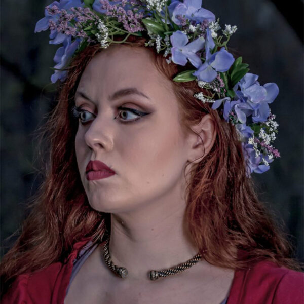 A woman with long red hair wearing a flower crown and a Celtic Spiral Torc - Medium Braid.