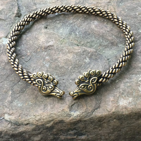 A bracelet with a braided design on top of a rock.