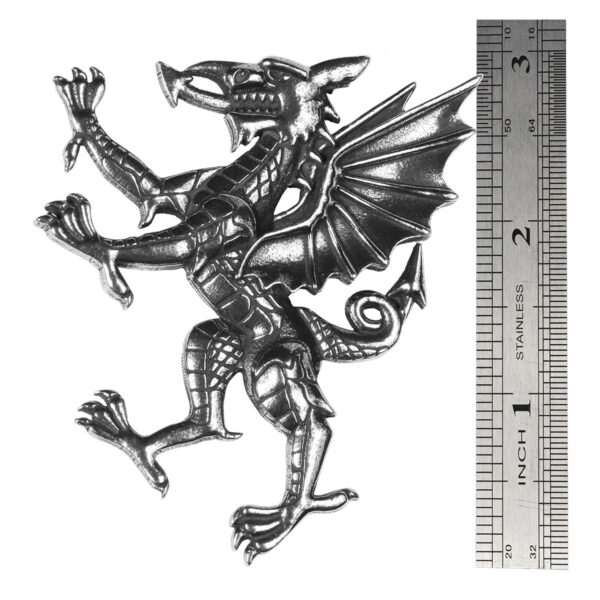 A Welsh Dragon Rampant Kilt Pin/Brooch is shown next to a ruler.