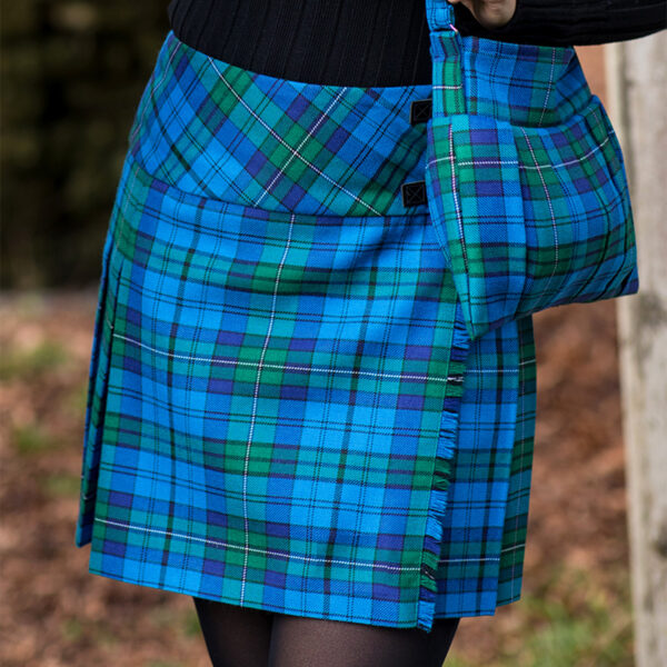 A woman wearing a Welsh Tartan Medium Weight Premium Wool Billie-Style Kilted Mini Skirt.