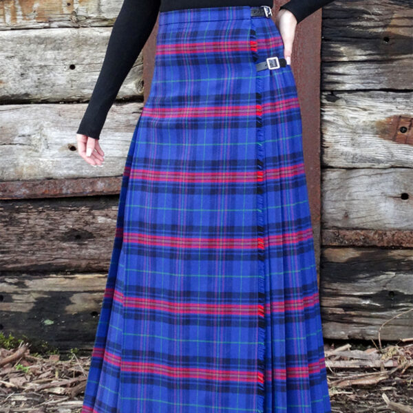 A woman wearing a Welsh Tartan Medium Weight Premium Wool Hostess Kilted Skirt.