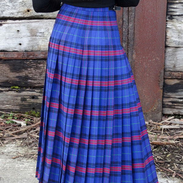 A woman wearing a Welsh Tartan Medium Weight Premium Wool Hostess Kilted Skirt.