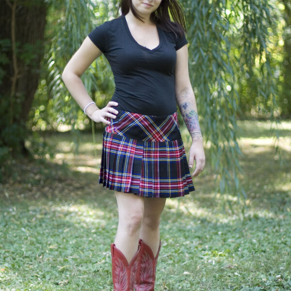 A woman donning a Homespun Wool Blend Billie Mini Skirt and cowboy boots.