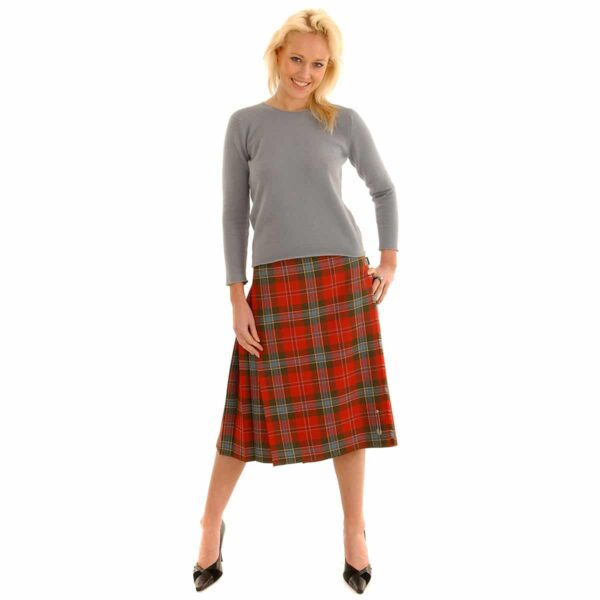 A woman is posing in a Light Weight Premium Wool Kilted Skirt.