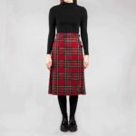 A woman wearing an Old & Rare Tartans Standard Ladies' Kilted Skirt.