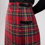 A woman wearing an Old & Rare Tartans Standard Ladies' Kilted Skirt.