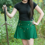 A woman in a Ladies Wilderness Mini Kilt brandishing a sword.
