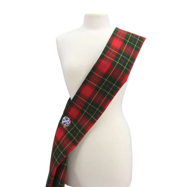 A mannequin with a red and green tartan sash.