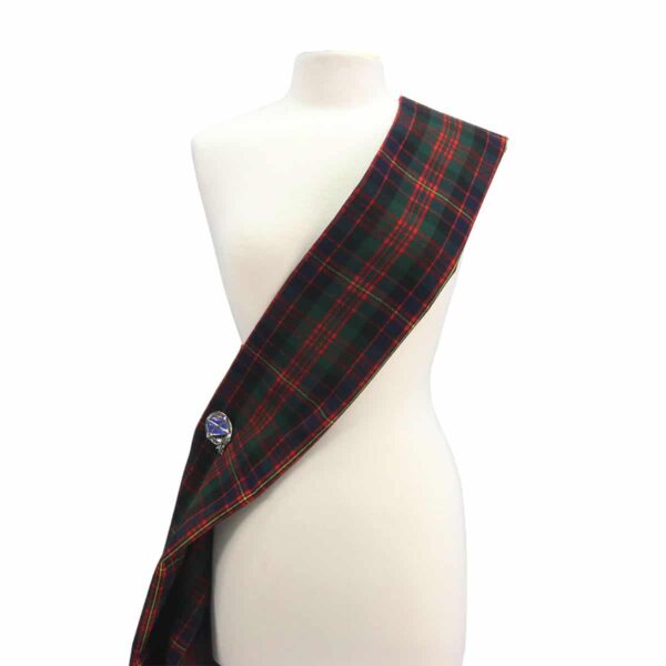 A mannequin wearing a green and red tartan sash.