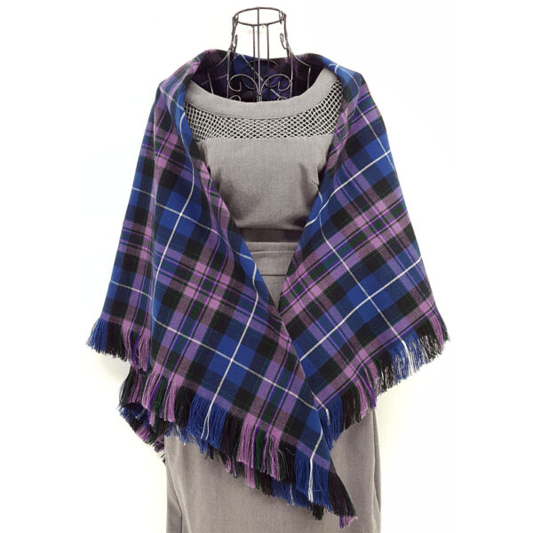 The Spring Weight Tartan Shawl, with fringes, is displayed on a mannequin.