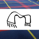 A blue and yellow tartan with the letter m on it, worn as a STARFLEET Tartan Stole.