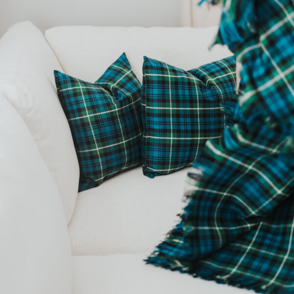 A Homespun Tartan blanket/throw on a white couch.