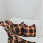 A Homespun Tartan Blanket/Throw on a white couch.