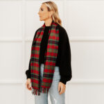 A woman sporting a stylish Tartan Scarf - Scottish Lambswool.
