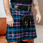 A man wearing a Quality Wool Blend Kilt with Matching Tartan Flashes and FREE Kilt Hanger.
